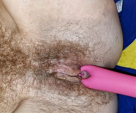 He penetrates her hairy pussy with a vibrator and her vagina gets wetter and wetter inside.